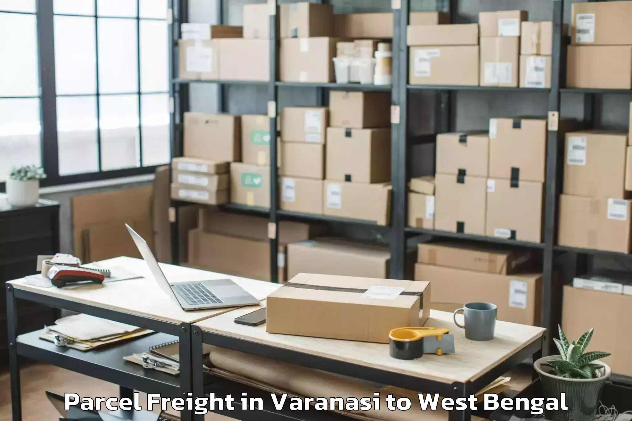 Varanasi to Tufanganj Parcel Freight Booking